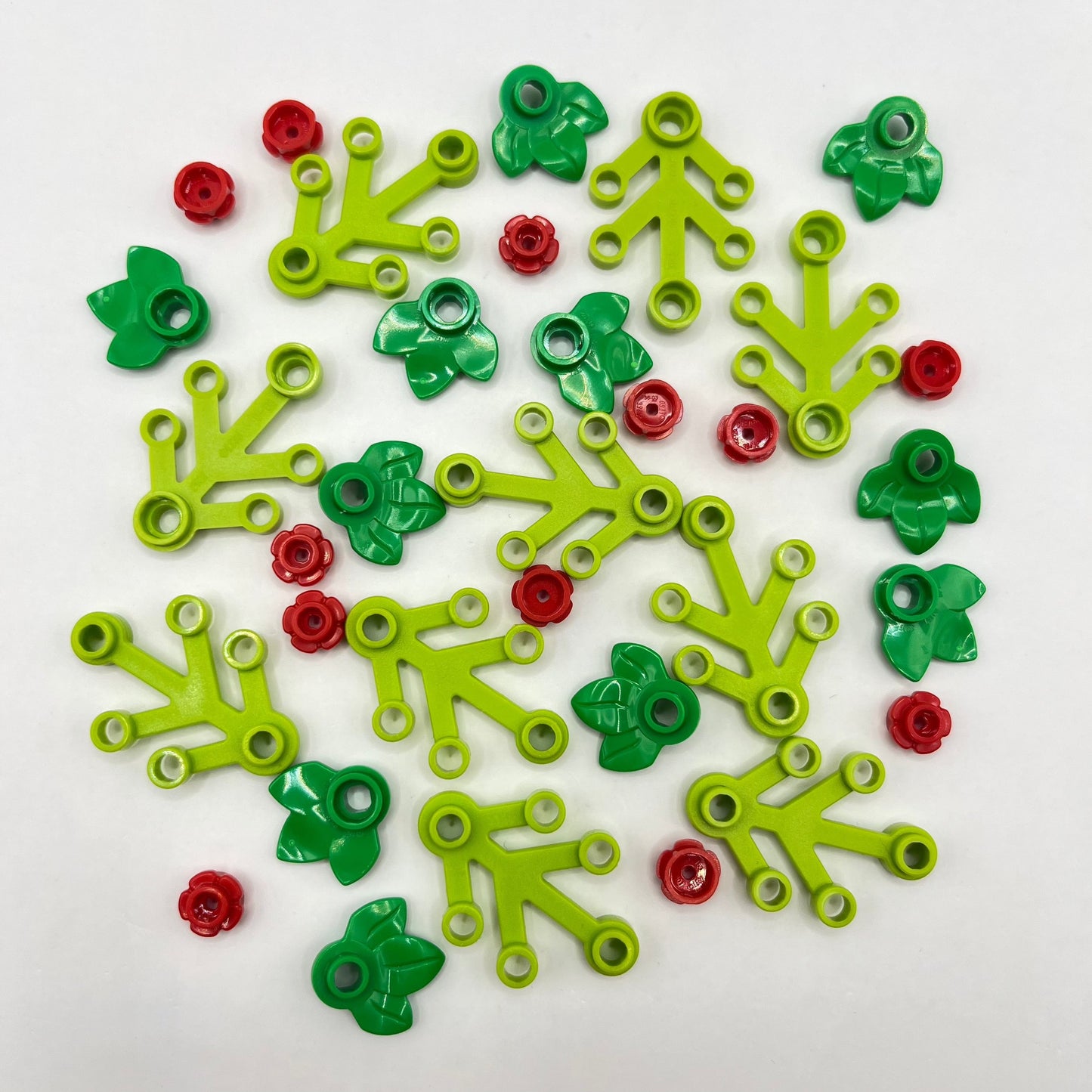 Decorative LEGO Christmas wreath made of Green, Red and Gold, with White leaves on a white background